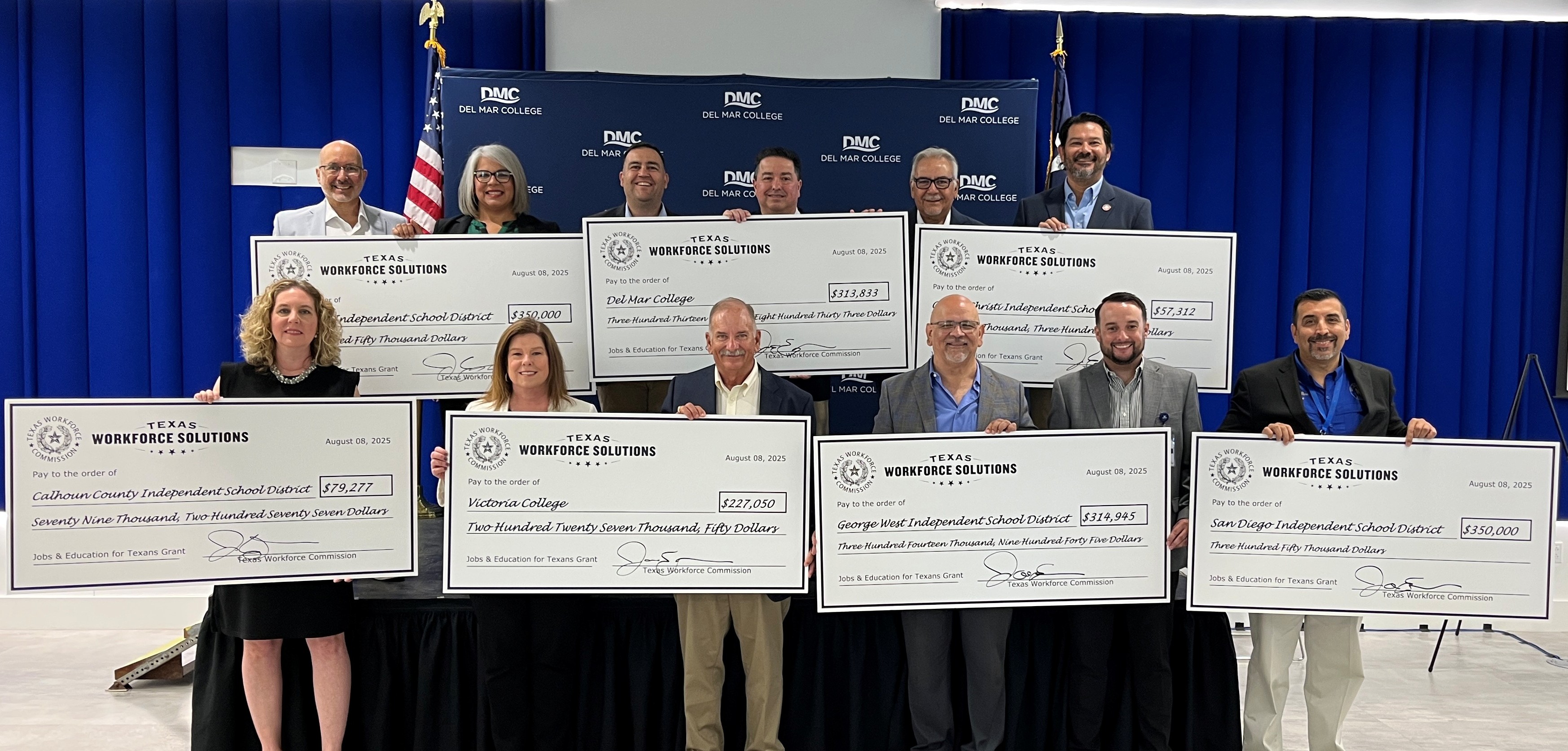 TWC Commissioner Representing Employers Joe Esparza stands with local partners in front of ceremonial grant checks.