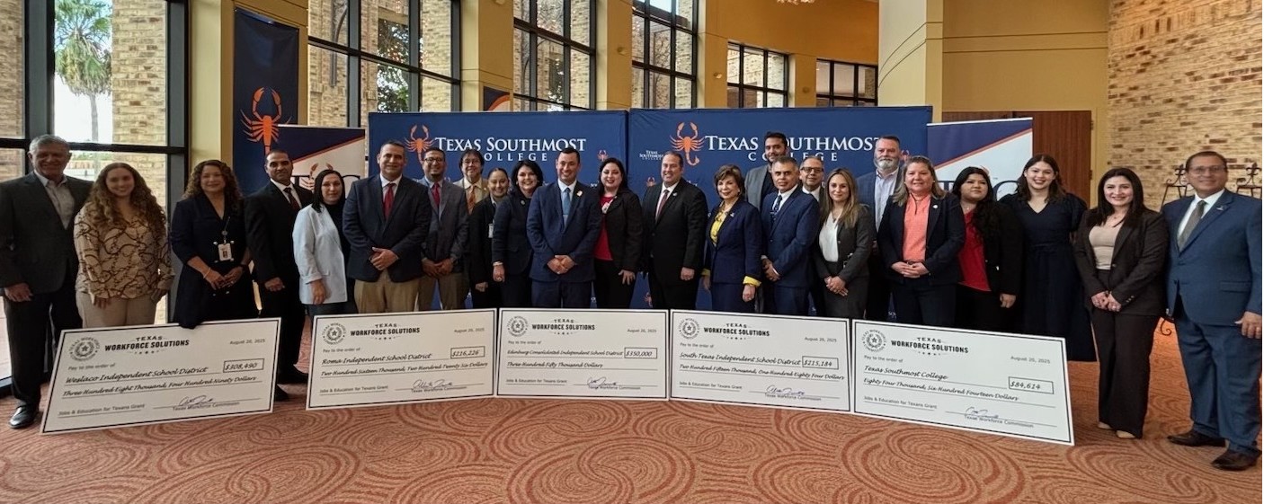 TWC Commissioner Representing Labor Alberto Treviño III and local partners standing behind ceremonial grant checks.