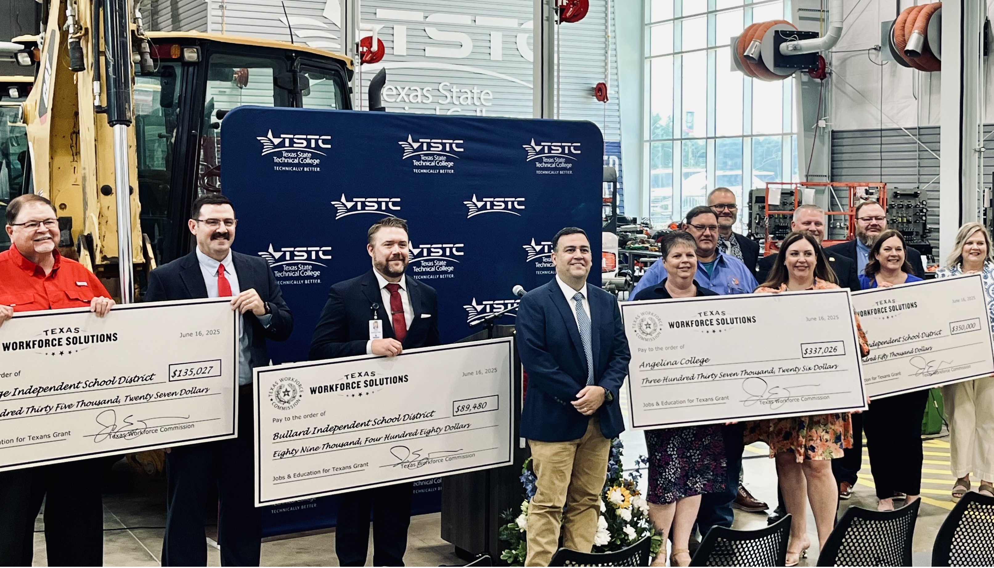 TWC Commissioner Representing Employers Joe Esparza presents ceremonial big checks to local partners in East Texas.