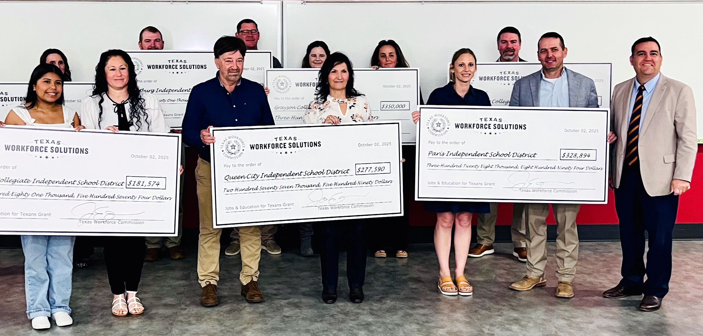 TWC Chairman Joe Esparza and local partners pose with ceremonial JET grant checks