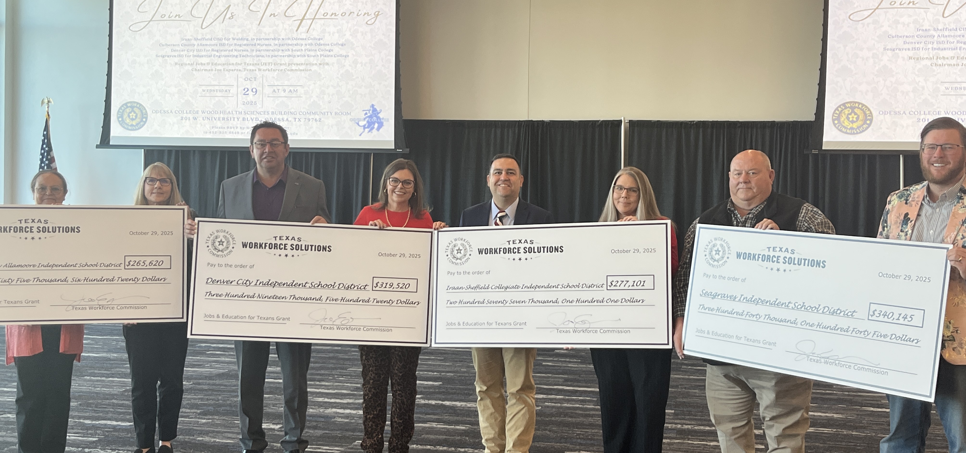 TWC Chairman Joe Esparza and local partners hold ceremonial grant checks at JET grant presentation ceremony.