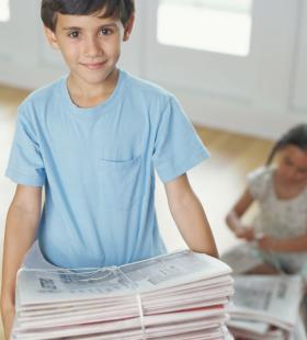 boy holding newspapers
