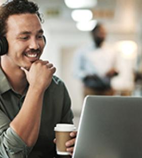 man using laptop at a coffee shop