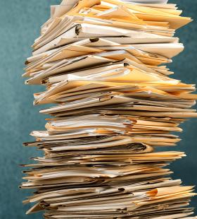 A stack of documents in folders.