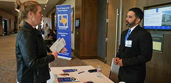 Two people talking at a Texas Conference for Employers event