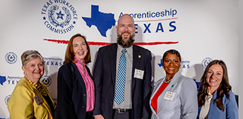 A man and two women attending the Apprenticeship Texas Conference.