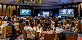 Attendees of the 2024 ApprenticeshipTexas conference seated in a ballroom listening to a presenter