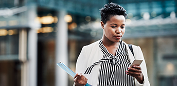 A female employer paying employer taxes on her cell phone.