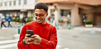 A man using his phone to find a job posting on MyTXCareer.