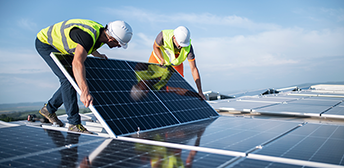 Two men working on a solar panel