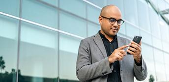 A man holding a phone and using AI features in the WIT website.