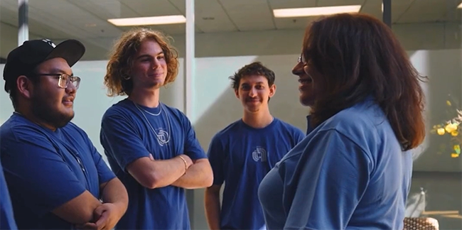 Woman talking to a group of apprentices.