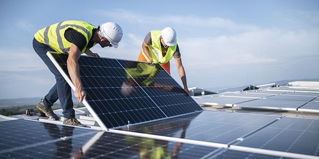 Two men working on a solar panel