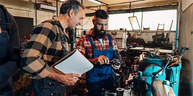 Two mechanics working together