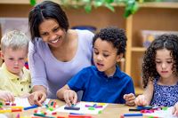 Teacher with children in a classroom setting