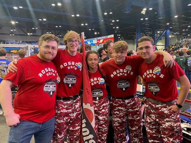 youth robotics team in red uniform