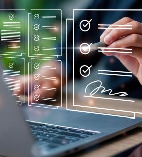 Completing an online form and writing a signature on a computer.
