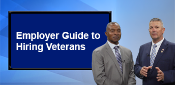 Two men standing in front of a presentation that says 'Employer Guide to Hiring Veterans'