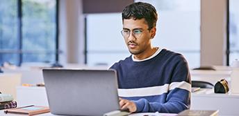 A person sitting at a desk with a computer